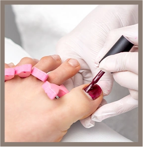 Hands painted red nail polish toes